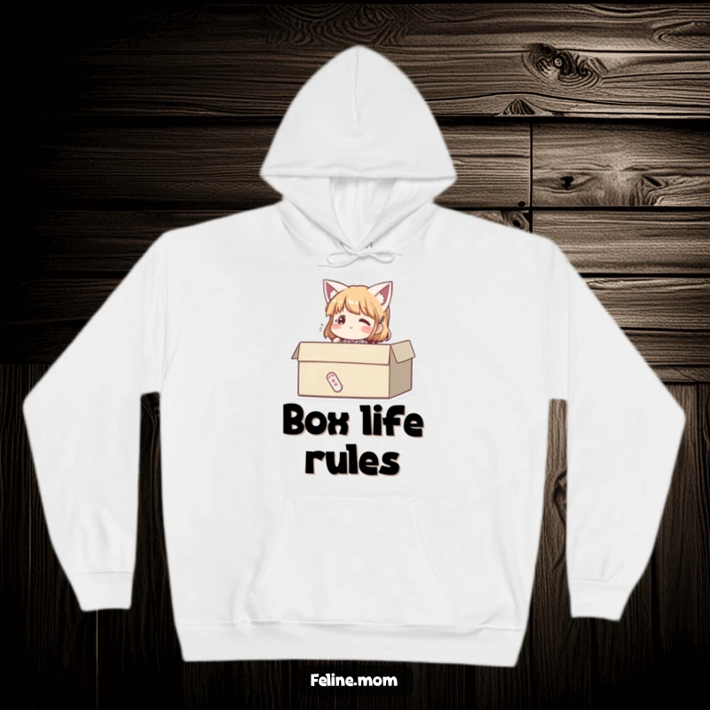 Funny hoodie showing a woman sitting contentedly in a cardboard box, embodying pure feline happiness. A humorous cozy gift.