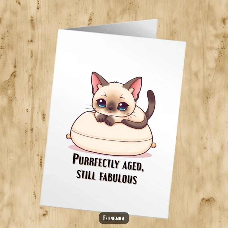 Funny Free Printable birthday card of a Siamese cat lounging regally on a cushion, radiating sophisticated and comical birthday wishes.