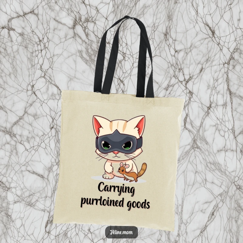 Funny tote bag showcasing a mischievous cat bandit in a mask, holding a toy mouse, perfect for shopping.
